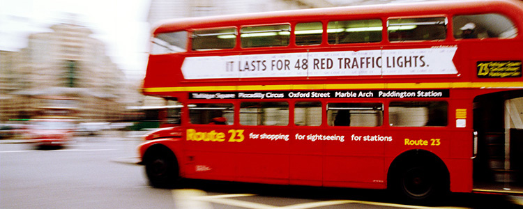 de_0071_england - Side profile of a double Decker bus in a city street